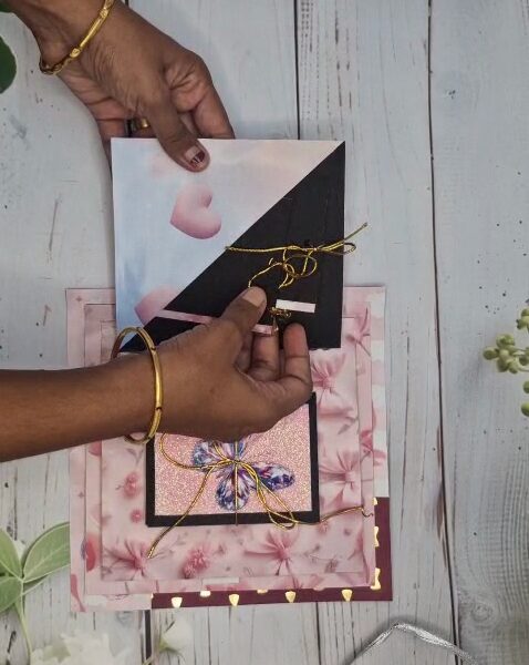 Personalised pyramid photo album opening to reveal layered photos