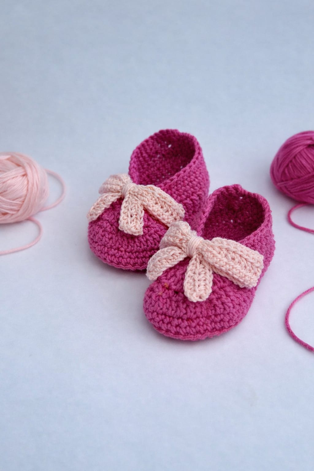 Handmade pink crochet baby booties with bow crafted in Kerala
